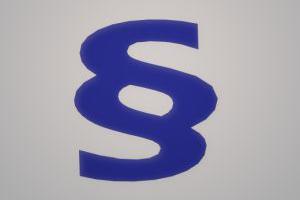 Blaues Paragraphenzeichen auf grauem Grund