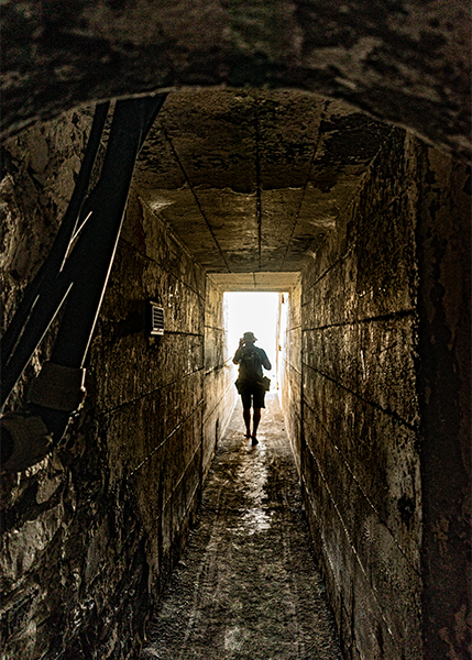 Ein Mann im Tunnel geht in die Richtung des Lichtes