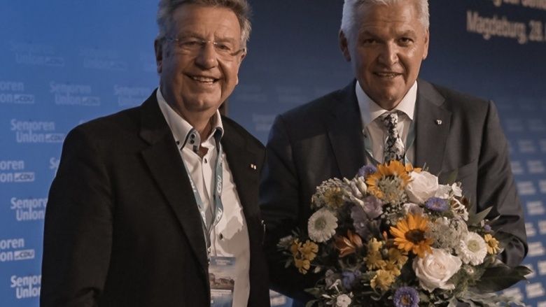 Helge Benda und Hubert Hüppe mit Blumenstrauß